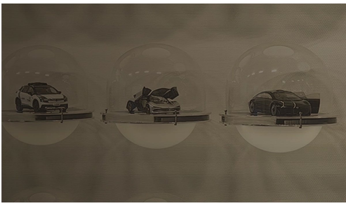 GAC vehicles displayed under glass domes