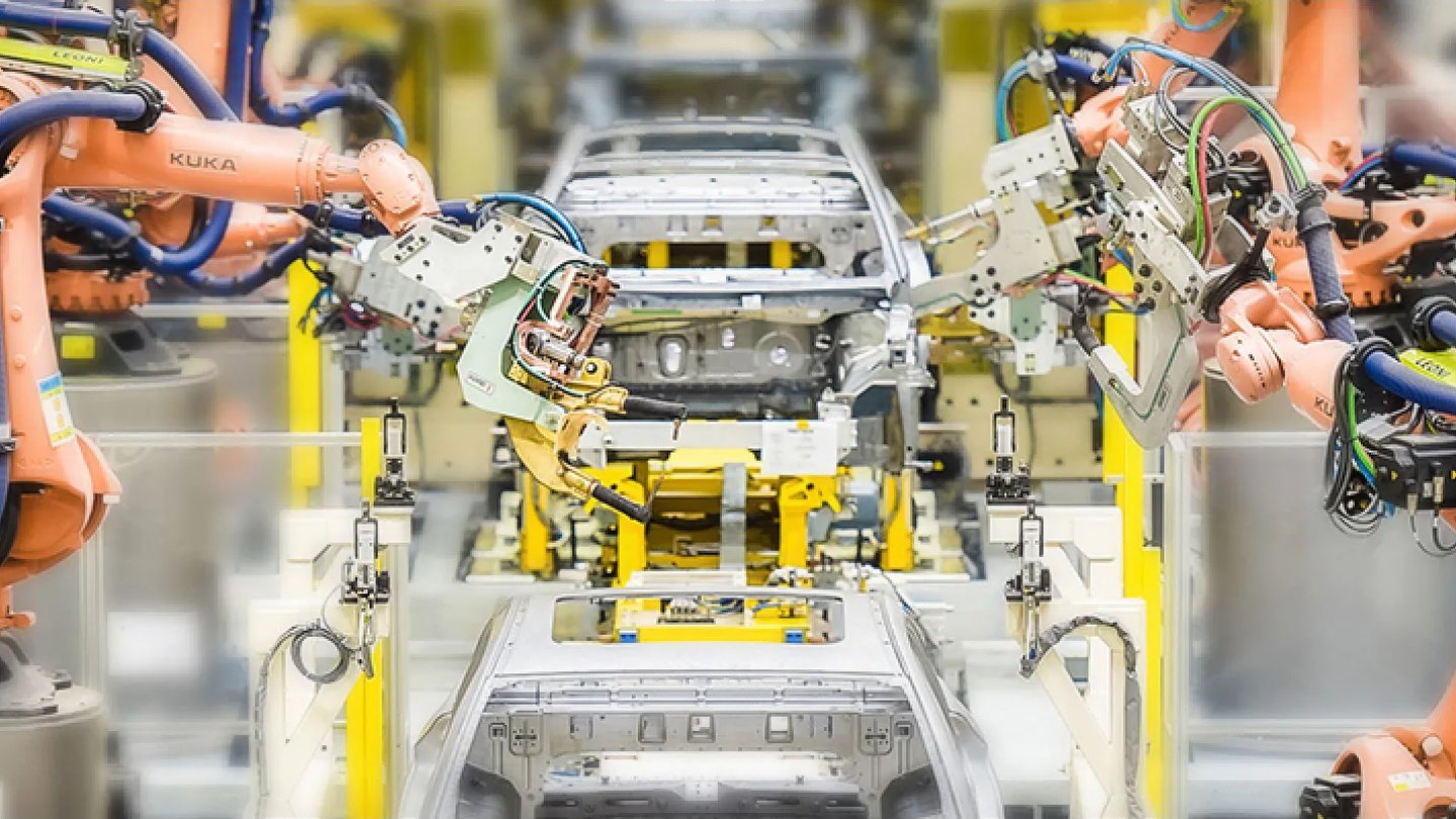 Robots joining a steel and aluminium body on the line