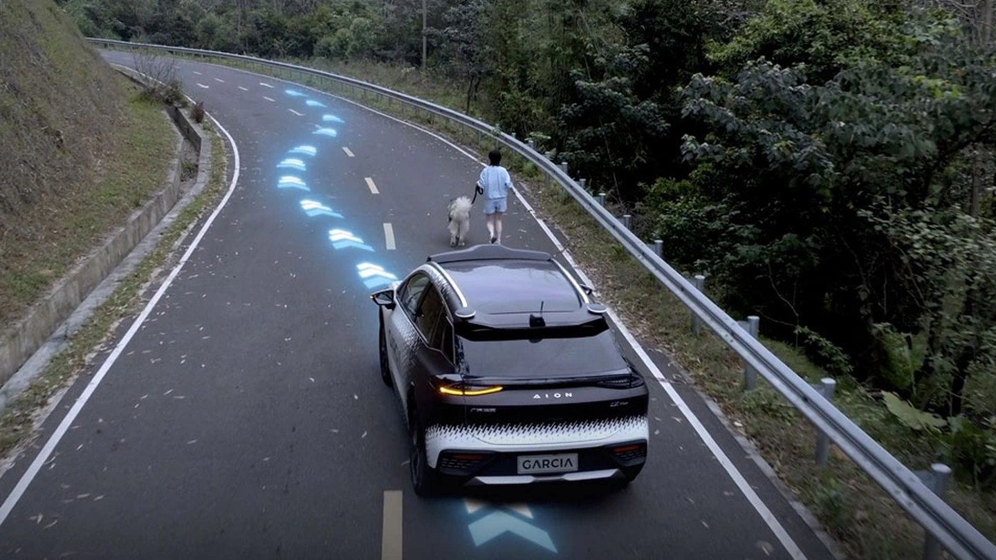 A Garcia-equipped car steering around a pedestrian and a dog