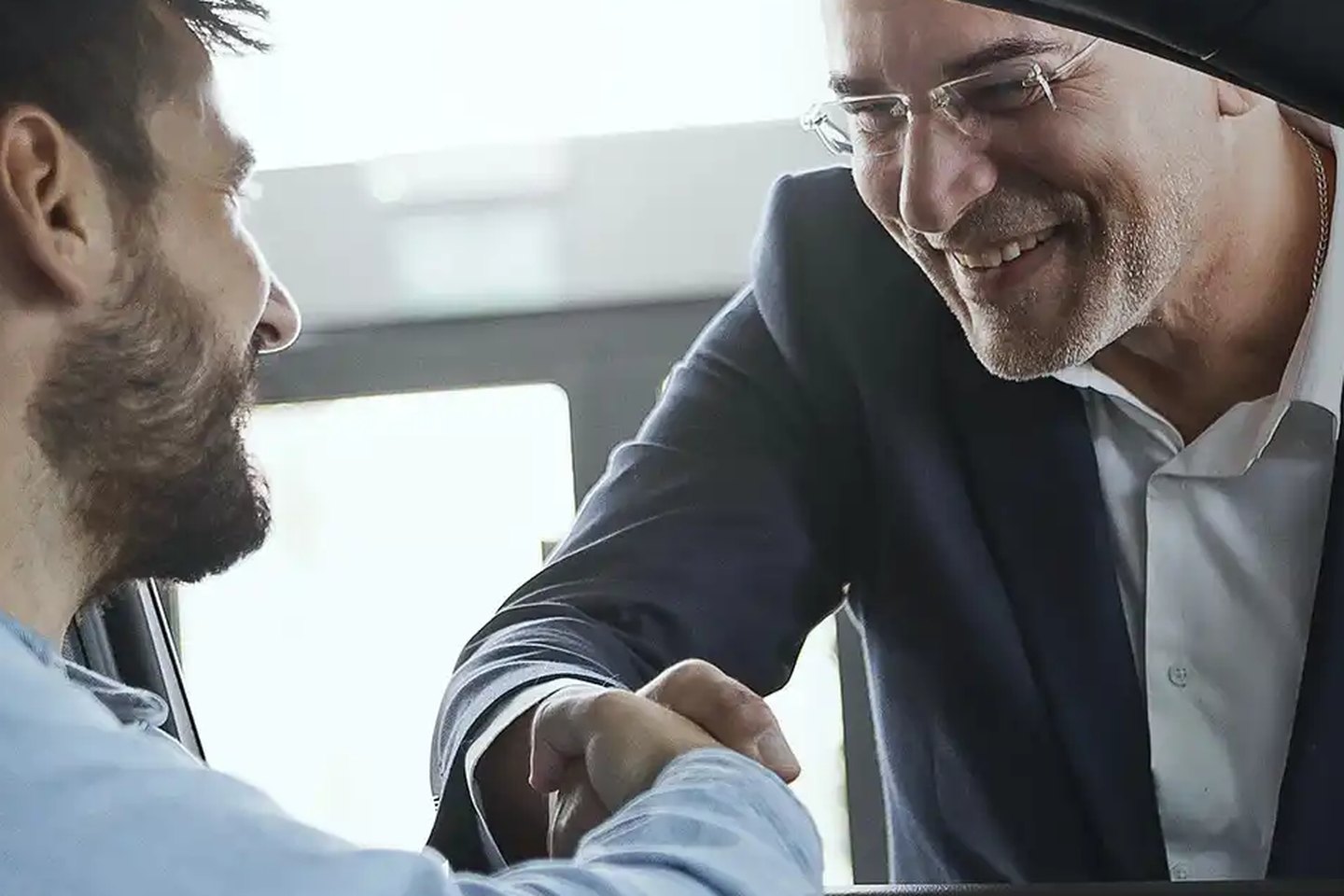 A GAC service advisor greeting a customer at the car